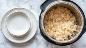 Instant pot brown rice perfectly cooked in pressure cooker showing fluffy texture and individual grains in stainless steel pot with serving bowl nearby