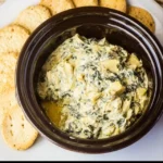 Crockpot Spinach and Artichoke Dip served in a bowl with chips