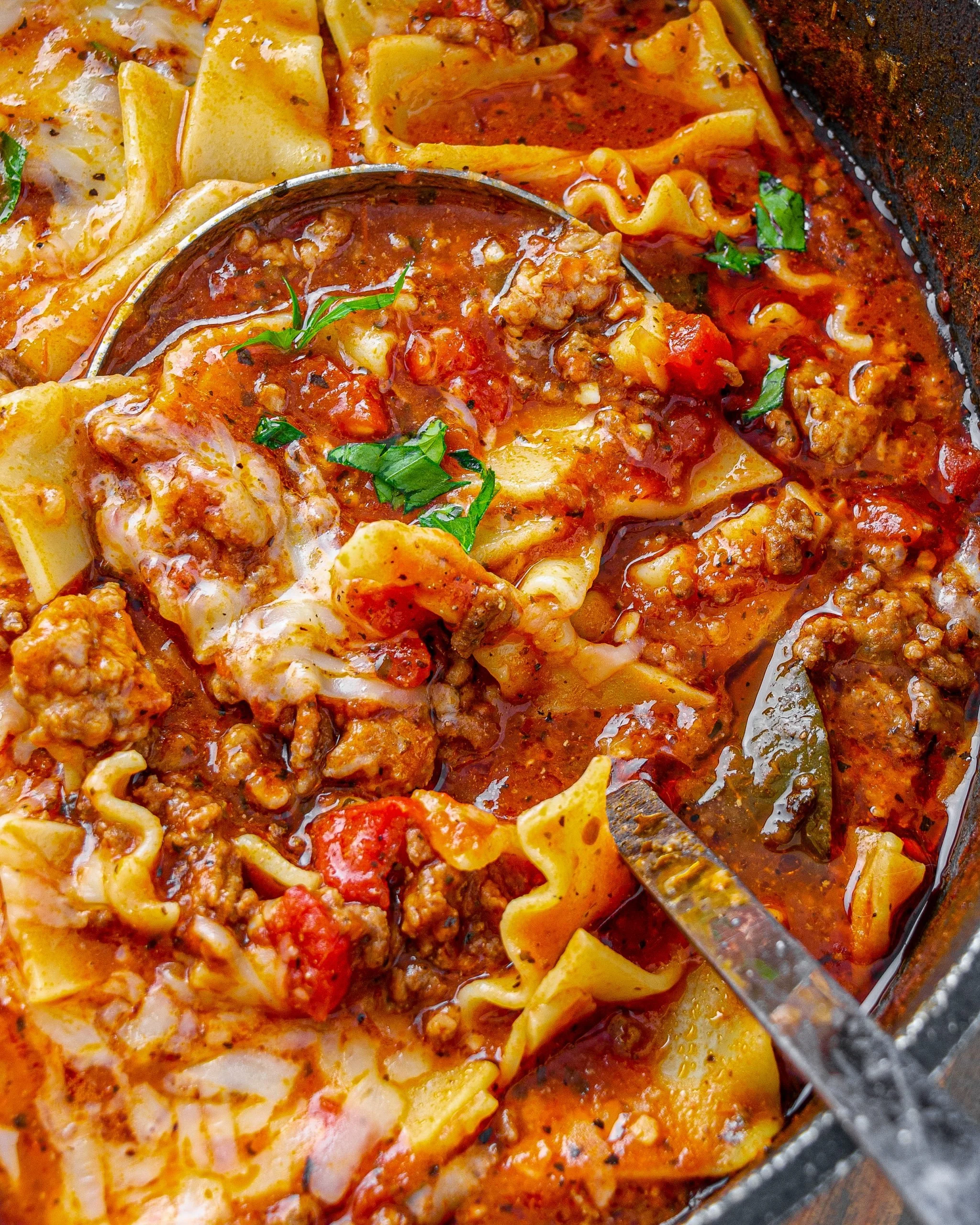 Delicious one-pot lasagna soup served in a bowl with fresh herbs