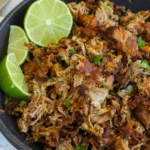 Delicious Crockpot Carnitas served in a taco with fresh toppings.