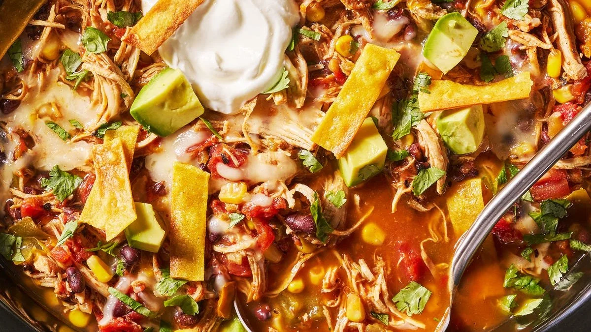 Bowl of flavorful Crockpot Chicken Tortilla Soup topped with tortilla strips and cilantro