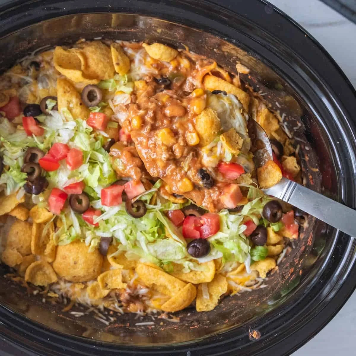 Delicious Crockpot Taco Casserole topped with cheese and served in a bowl