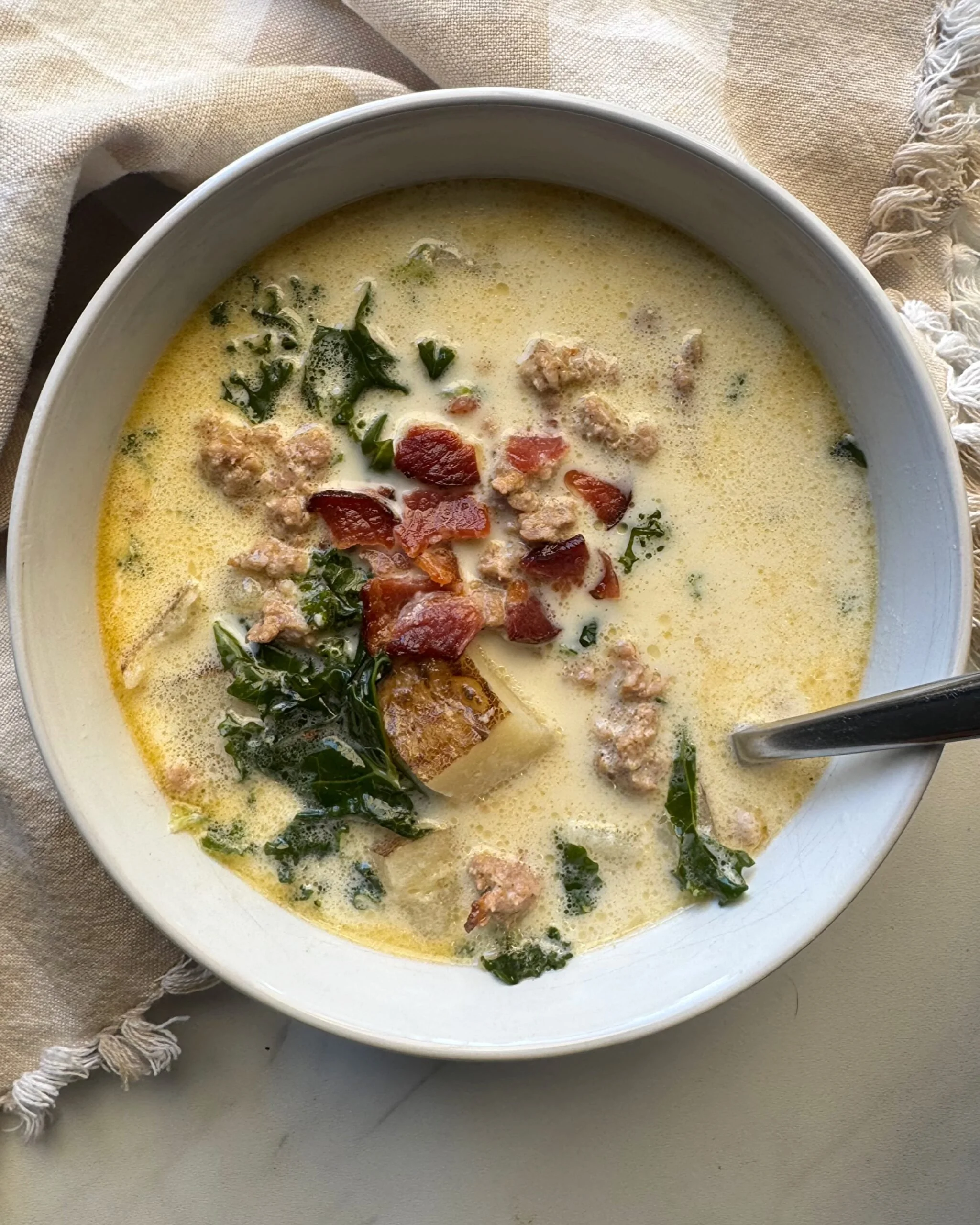 Healthy Slow Cooker Zuppa Toscana Soup in a bowl with fresh ingredients