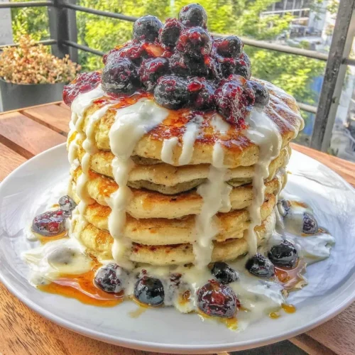 Cottage cheese blueberry protein pancakes stacked with fresh blueberries