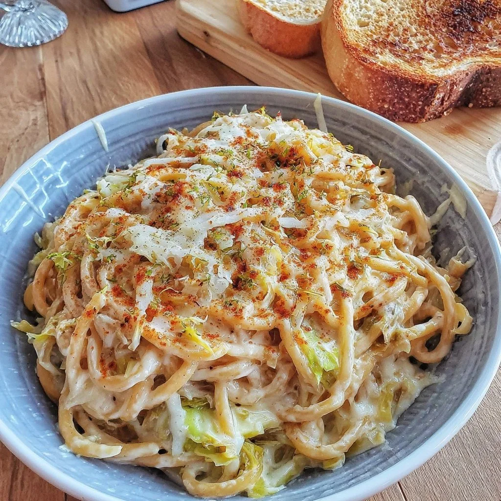 Creamy Cabbage Alfredo Pasta served in a bowl with fresh herbs