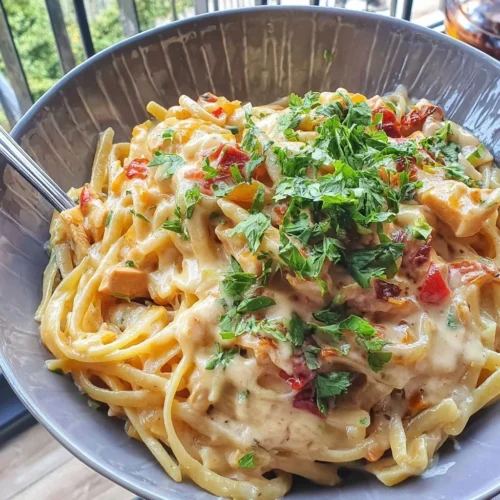 Bowl of creamy Cajun pasta with spices and fresh herbs