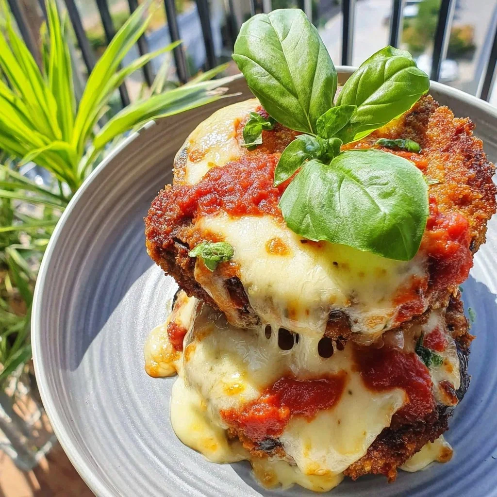 Crispy Air Fryer Eggplant Parmesan served with marinara sauce and basil garnish