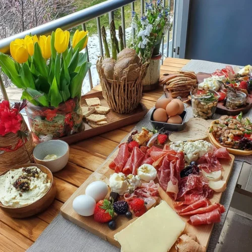 Colorful Spring charcuterie board for Easter with cheese, meats, and fruits