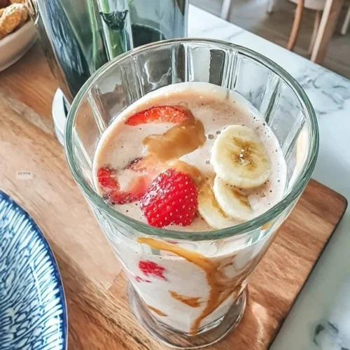 Energizing strawberry banana oat milk smoothie in a glass