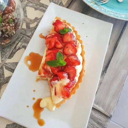 Delicious strawberry tart topped with fresh strawberries and creamy pastry cream