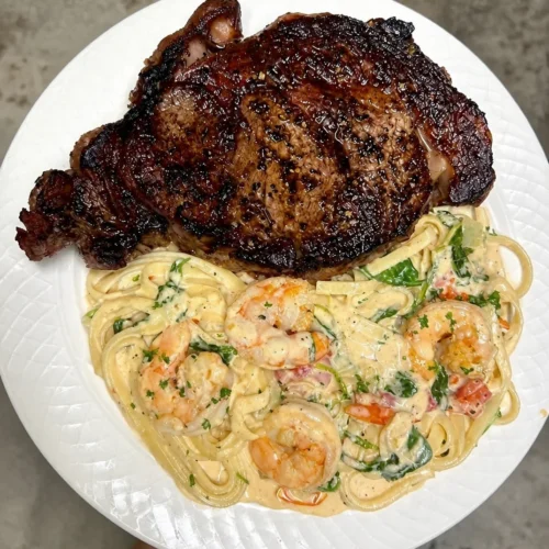 Creamy shrimp pasta with ribeye, cooked medium rare