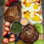 Ribeye and fried eggs board with fruit, avocados and dipping sauces 🔥🔥🔥🔥🔥🔥 Yummy