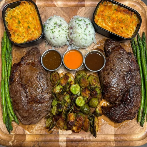 Ribeye Board with Baked Mac, Asparagus, Honey Balsamic Roasted Brussels Sprouts and Mashed Potatoes – Protein-rich, fibre-packed and comforting