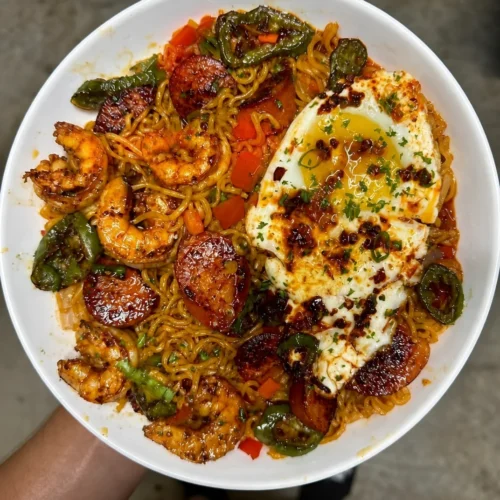 Shrimp and Sausage Stir Fried Ramen with a Chili Oil Fried Egg 11 Shrimp and sausage stir fried ramen topped with a chili oil fried egg.